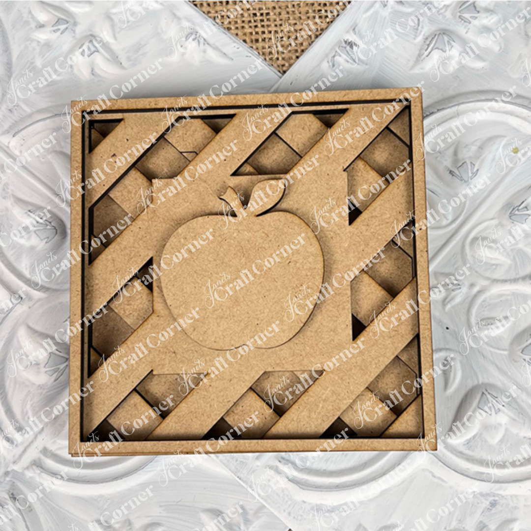 The Apple on Lattice Square by Janet's Craft Corner is a square, unfinished wooden cut-out with a lattice pie design and central apple. Perfect for DIY seasonal decor, it’s displayed on white textured patterns and burlap—ideal for small spaces.