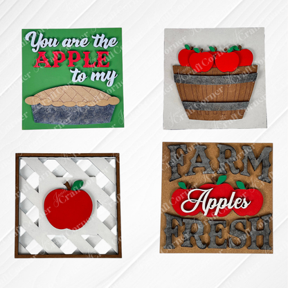 Janet's Craft Corner Apple Squares features four farmhouse-style wood signs with apple designs, displayed on a white wood background.