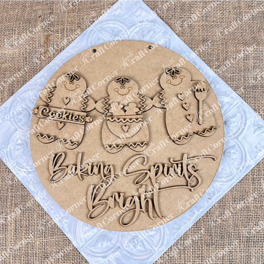 Janet's Craft Corner's Baking Spirits Bright Wall Hanger DIY kit features three gingerbread figures with a "Cookies" sign and "Baking Spirits Bright" engraved below, perfect for adding festive charm to your seasonal home decor. Set of 1.