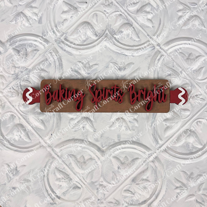 The Vintage Santa Cookies Decor Set by Janet's Craft Corner is a DIY craft kit with a wooden rolling pin featuring red handles and "Baking Spirits Bright" in red script, perfect for holiday tiered trays or festive home decor.