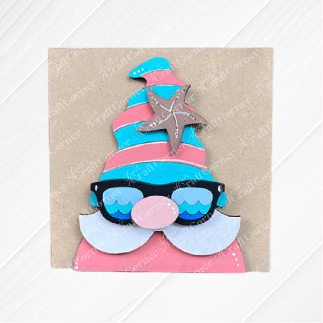 The Summer Lovin Swappable Squares DIY craft kit by Janet's Craft Corner features a whimsical gnome with a pink and blue striped hat, starfish, wave-pattern sunglasses, and white beard—ideal for summer home decor projects.