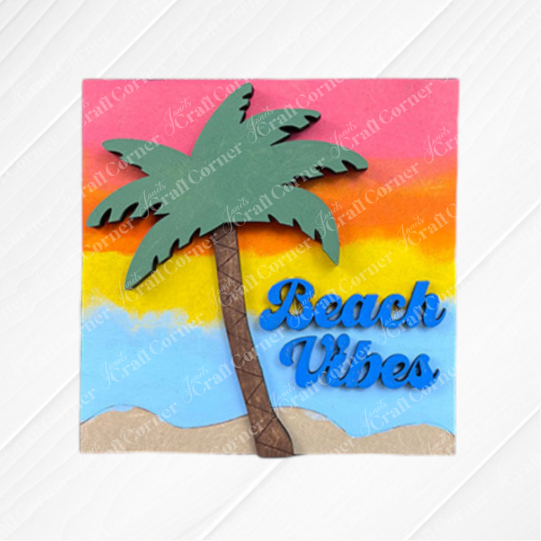 The Summer Beach Squares DIY craft kit by Janet's Craft Corner features a colorful palm tree on sand with a sunset and "Beach Vibes" in blue text—ideal for coffee bar decor or tiered tray signs, adding coastal flair to any space.