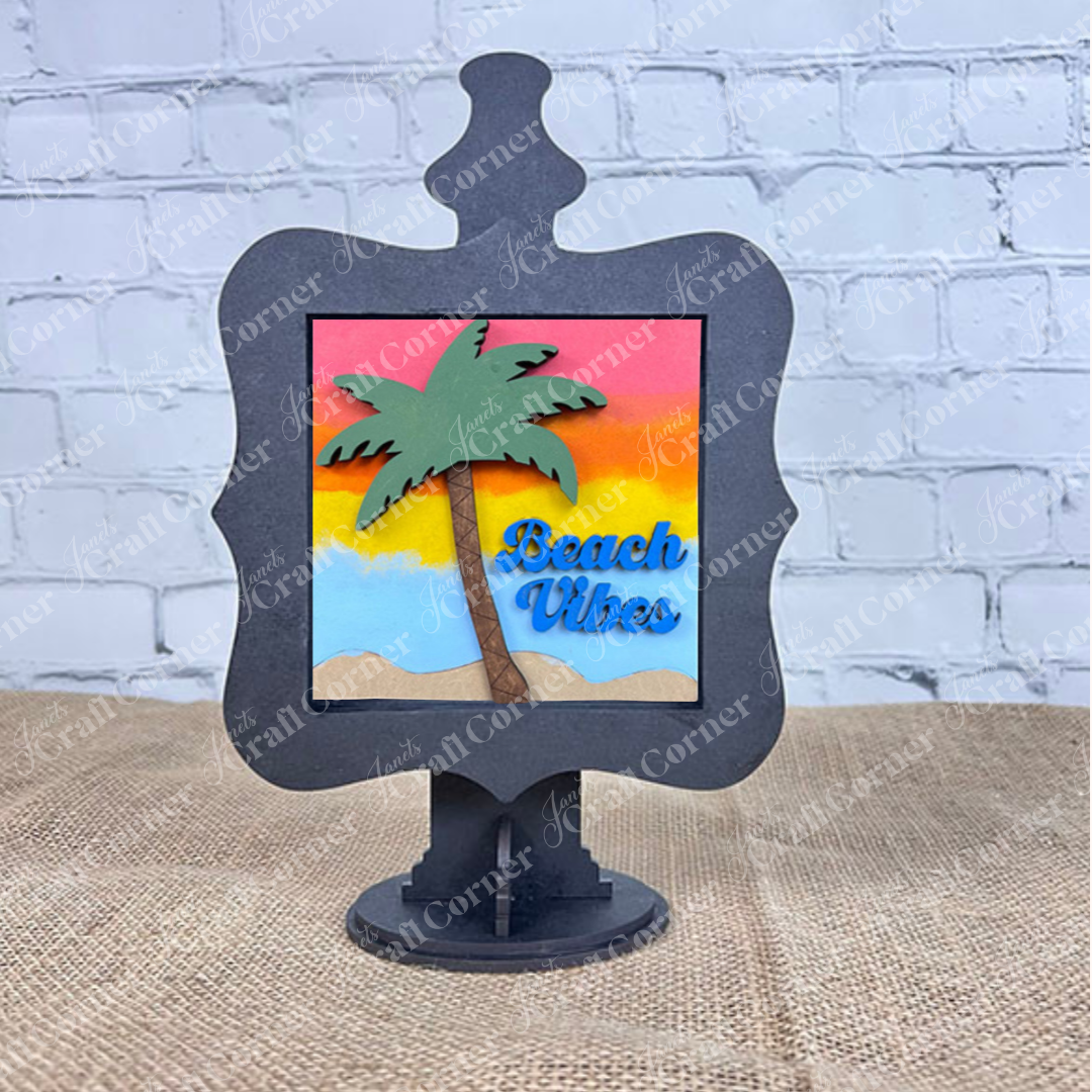 Add a splash of summer to your coffee bar with Janet's Craft Corner’s Summer Beach Squares DIY kit—a decorative tiered tray sign featuring a palm tree and "Beach Vibes" in blue, set against a sunset, framed in black for eye-catching seasonal decor.
