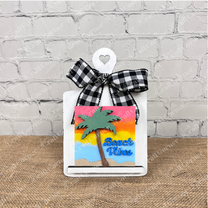 The Summer Beach Squares DIY craft kit from Janet's Craft Corner is a small decorative cutting board with a checkered bow and “Beach Vibes” sign—ideal for summer tiered tray displays or coffee bar decor in any small space.