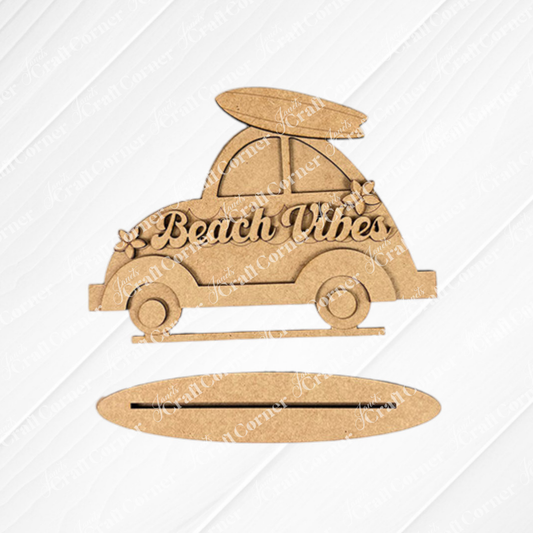 The Beach Vibes Volkswagen Shelf Sitter by Janet's Craft Corner is a DIY home decor kit. Shaped like a vintage car with a surfboard, floral details, and "Beach Vibes" inscription, it complements textured white or burlap backgrounds.