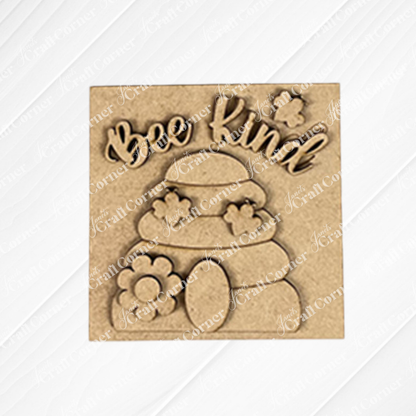 The Bee Swappable Squares by Janet's Craft Corner features "Bee Kind" above a beehive with flowers and a bee, handmade for charming home decor on a textured white background.