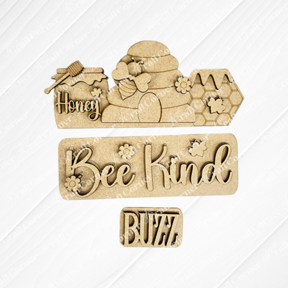 The *Bee Interchangeable Insert* by Janet's Craft Corner is a hand-painted DIY home decor kit featuring wooden cutouts on a textured background. It includes designs of bees, honeycombs, and a beehive, alongside charming phrases such as "Honey," "Bee Kind," and "Buzz." This kit is perfect for refreshing your space with interchangeable decor.