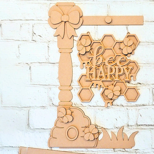 Janet's Craft Corner presents the Bee Happy Street Post Shelf Sitter, a charming DIY home decor kit: a wooden piece with hexagonal honeycomb shapes and "bee HAPPY" text, perfect for adding charm to your white brick wall.