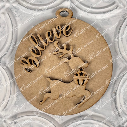 Introducing Janet's Craft Corner's "Round Christmas Ornaments | DIY Decoration Kits": A delightful round wooden ornament showcasing a reindeer silhouette and the word "Believe" elegantly cut out. Its textured, decorative pattern in soft light gray tones makes it a perfect addition to your holiday decor and an ideal piece for any Christmas ornaments collection.