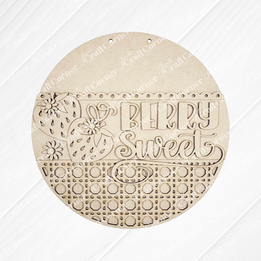 The Berry Sweet Wall Hanger - Summer DIY Craft Kit by Janet’s Craft Corner is a 10.5" round wooden sign with engraved strawberries, flowers, “Berry Sweet” script, and a geometric cut-out pattern—perfect farmhouse wall décor for your space.