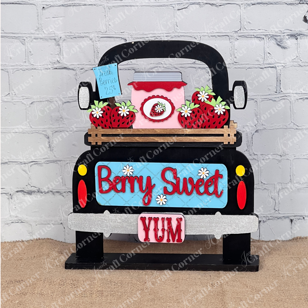 Janet's Craft Corner's "Berry Sweet" Interchangeable Insert DIY kit features a charming farmhouse design with a pickup truck, strawberries, and a "YUM" plate against a white brick wall. Perfect as vinyl decals, these 3-piece sets add rustic charm to any space.