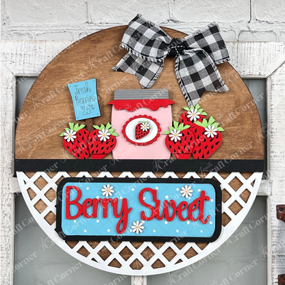 Introducing the "Berry Sweet Interchangeable Insert" from Janet's Craft Corner, a delightful DIY home decor kit. This charming farmhouse piece combines strawberries, a heart-shaped jar, and a "Fresh Berries 25¢" label. The phrase "Berry Sweet" stands out in red on blue with white daisies, complemented by a black and white checkered bow at the top.