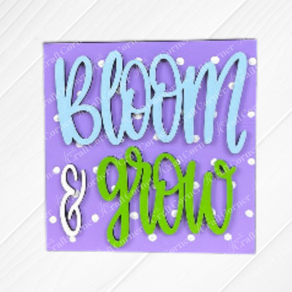 The Bloom & Grow Squares by Janet's Craft Corner features a purple sign with white polka dots and colorful lettering—ideal for tiered tray decor or as part of your Swappable Squares wood sign kit.