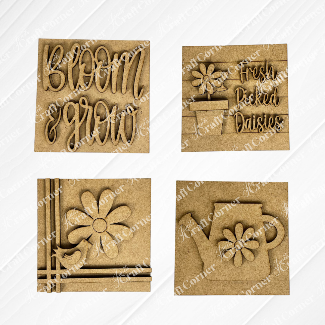 Janet's Craft Corner "Bloom & Grow Squares" includes four wooden plaques: "Bloom & Grow" text, "Fresh Picked Daisies," a daisy with bird, and a watering can—ideal spring Swappable Squares for small space decor.