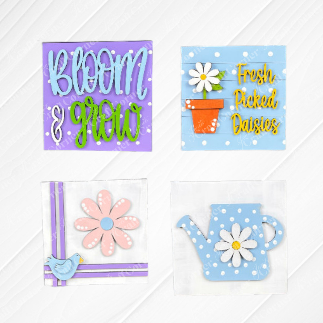 Add spring cheer with Bloom & Grow Squares by Janet's Craft Corner: includes "Bloom & Grow" with flowers, "Fresh Picked Daisies" sign kit, a pink daisy and blue bird, and a blue polka-dot watering can for your tiered tray.
