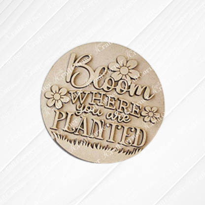 The Hello Spring Decor Set - DIY Craft Kit (5 pieces) by Janet's Craft Corner features round wooden farmhouse-style plaques with floral designs and "Bloom where you are planted" engraving—perfect for spring décor or DIY projects.