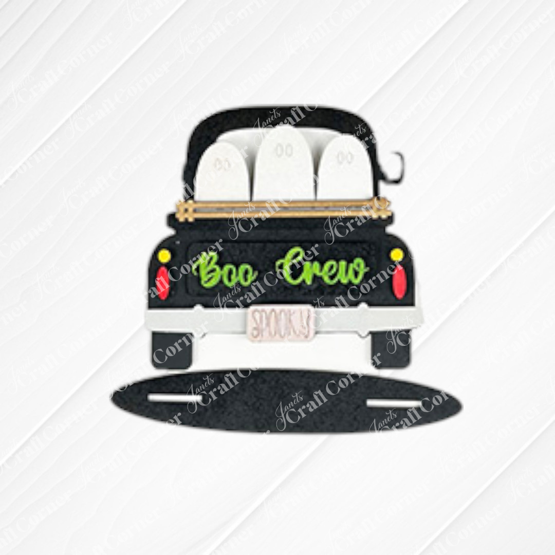 The Halloween Mini Shelf Sitters kit by Janet's Craft Corner features a cartoon car with three white ghosts, "Boo Crew" on the trunk, and a "Spooky" license plate—perfect DIY decor for adding Halloween flair to your home. Set of 1.