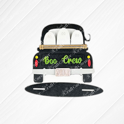 The Halloween Mini Shelf Sitters kit by Janet's Craft Corner features a cartoon car with three white ghosts, "Boo Crew" on the trunk, and a "Spooky" license plate—perfect DIY decor for adding Halloween flair to your home. Set of 1.