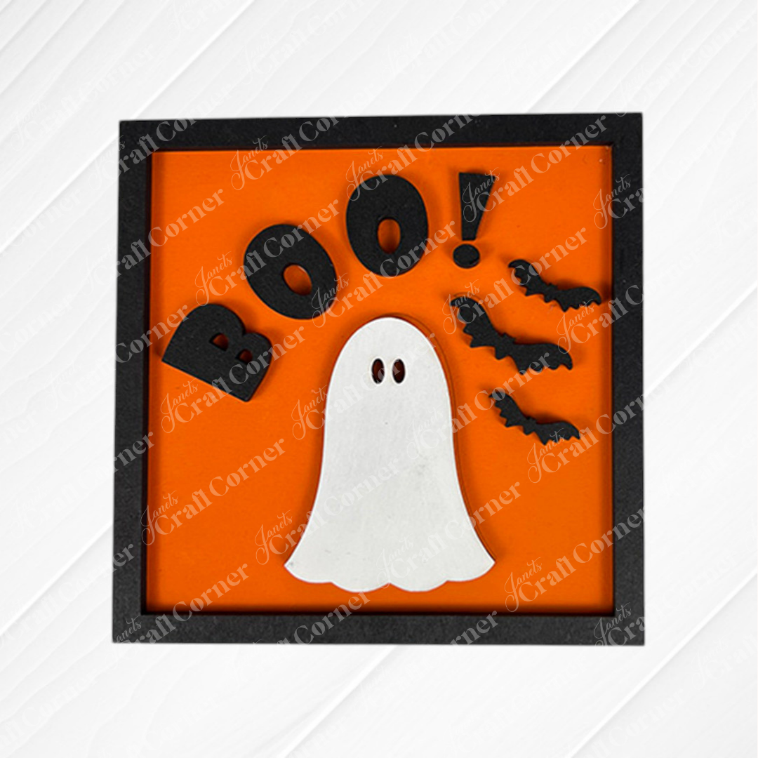 Janet's Craft Corner Oct 31 Squares: A framed orange sign with "BOO!" in black, a white ghost, and three bats—great for tiered trays or paired with other wood cut-outs for a festive Halloween display.