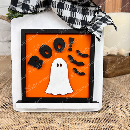 The "Oct 31 Squares" from Janet's Craft Corner features a white ghost, three bats, and "BOO!" on orange, topped with a checkered bow—perfect for your Halloween wood sign cut-outs or Swappable Squares!.