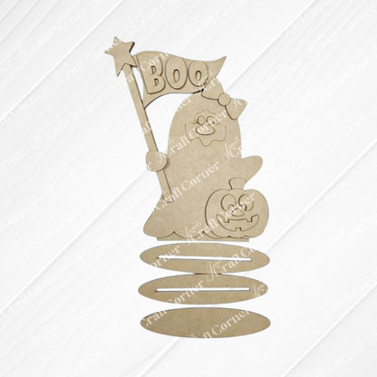 Add a touch of spooky-cute charm to your home with the Boo Ghostie Shelf Sitter from Janet’s Craft Corner—a DIY home decor craft kit featuring a cartoon ghost holding a “BOO” flag and accompanied by a jack-o’-lantern, all crafted from brown wood. This shelf sitter has wavy lines at the bottom that suggest flexibility or a spring, making it the perfect playful Halloween accent for your space. Set includes one Boo Ghostie Shelf Sitter.