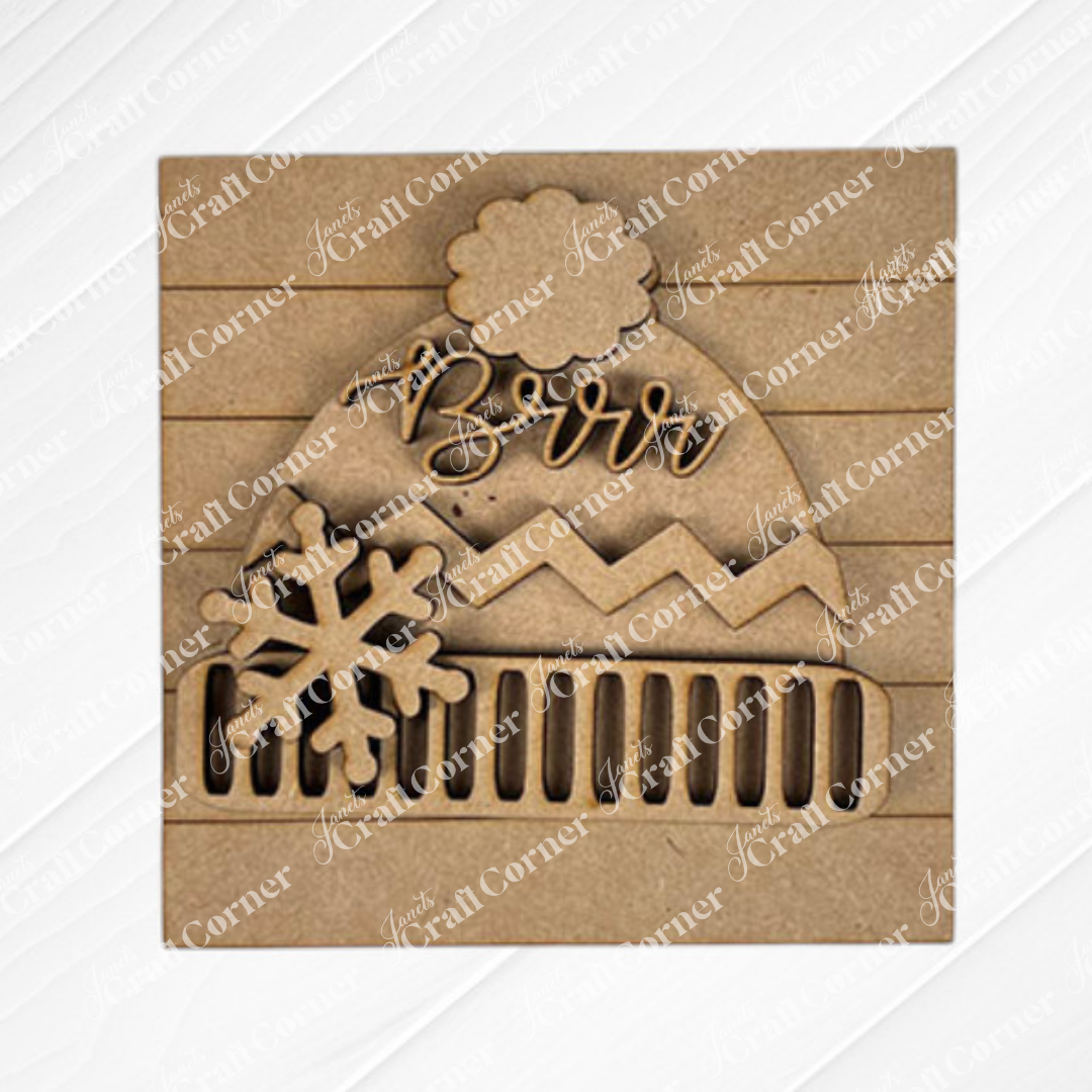 Add a charming touch to your decor with Janet's Craft Corner "Hello Winter Squares"—a laser-cut wooden ornament shaped like a winter hat with "Brrr," snowflake detail, and textured stripes, perfect for tiered trays or seasonal displays.