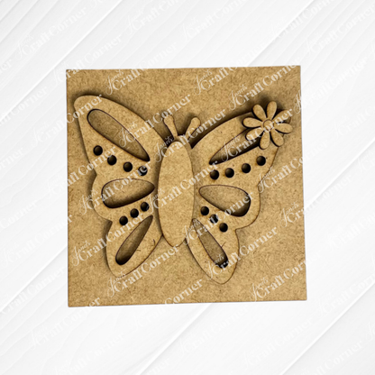 The "Hello Spring Squares" by Janet's Craft Corner is a square wooden panel with a cut-out butterfly, floral detail on one wing, and decorative holes—perfect for Swappable Squares displays or as cheerful tiered tray decor.