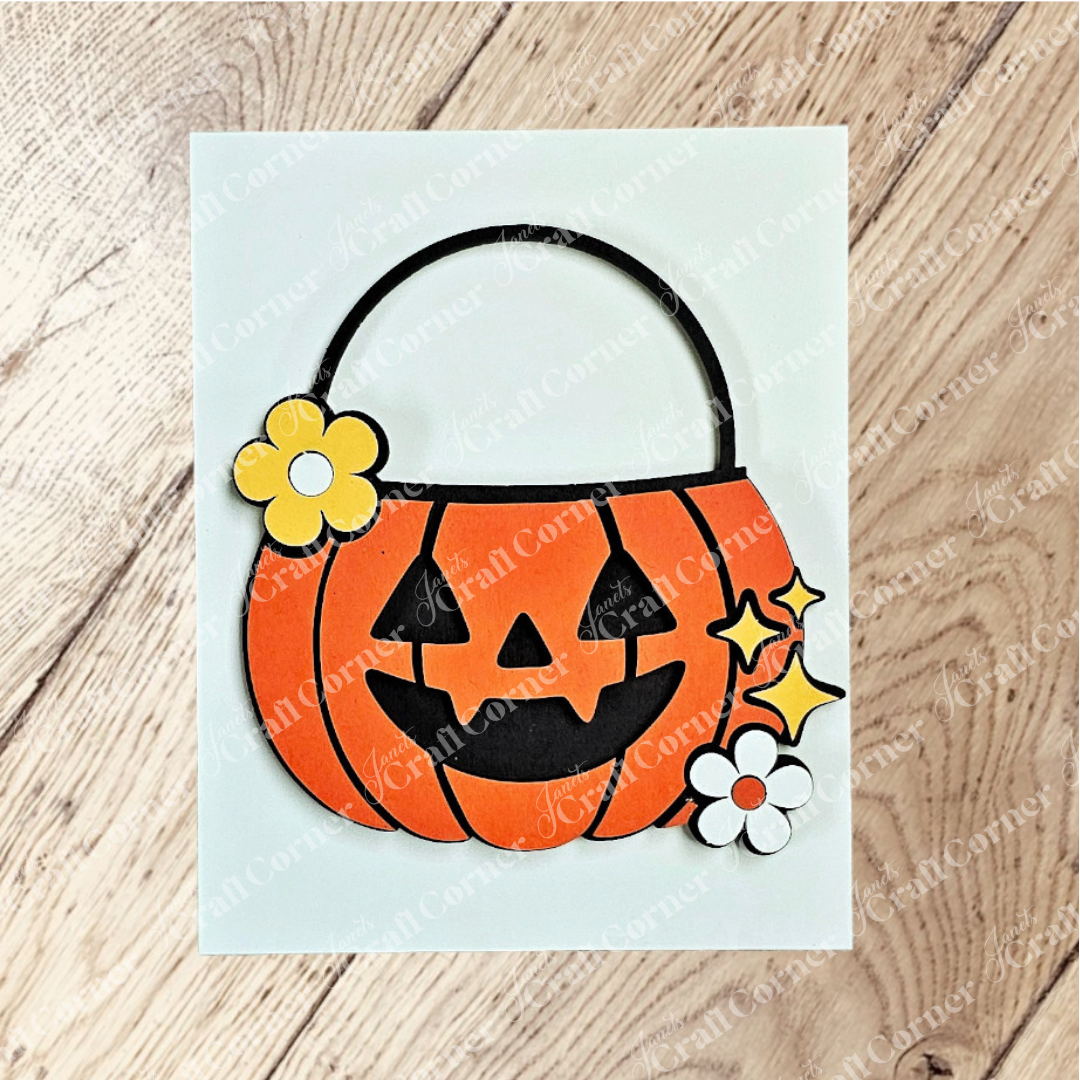 Janet's Craft Corner's Halloween Farmhouse Signs feature a smiling jack-o’-lantern with a black handle, floral accents, and sparkles on light wood—perfect inspiration for your next DIY seasonal decor project.