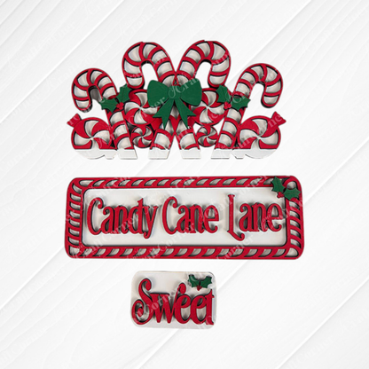Immerse yourself in the charm of Candy Cane Lane with the festive decorations from Janet's Craft Corner. This DIY home decor kit includes eight candy canes embellished with green bows and holly. A sign displaying "Candy Cane Lane" is framed with red and white stripes, while a smaller "Sweet" sign features holly on a textured background—perfect for your hand-painted projects.