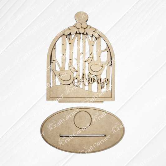The Cardinal Cloche Votive Holder Shelf Sitter by Janet’s Craft Corner is a laser-cut wooden ornament featuring two birds perched on branches inside a birdcage, with the word “Always” displayed beneath them. Sold as a set of 1 DIY home decor craft kit, this piece includes an oval base with a slot and a circular area for easy attachment, making it perfect for creating personalized cardinal-themed décor.