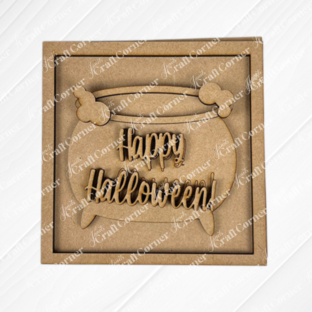 The "Oct 31 Squares" sign from Janet's Craft Corner is a laser-cut wooden cauldron with bones and "Happy Halloween" text, ideal for tiered trays or Swappable Squares, shown in a square frame on a light diagonal-striped background.