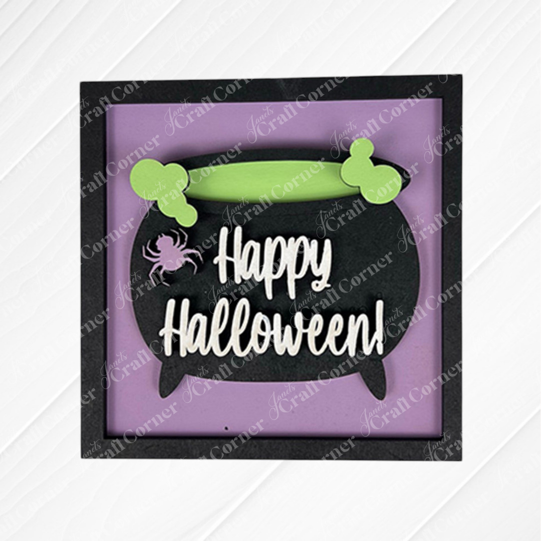 Janet's Craft Corner’s Oct 31 Squares is a framed Halloween sign with a black cauldron, green bones, a pink spider, and "Happy Halloween!" on purple—perfect for tiered trays or paired with wood cut-outs for festive decor.
