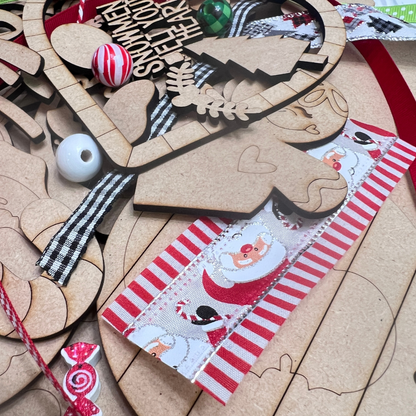 The Crafted by You! Subscription by Janet’s Craft Corner includes unfinished wooden Christmas shapes, festive ribbons, twine, and beads—everything needed for monthly DIY home decor projects or community crafting fun.