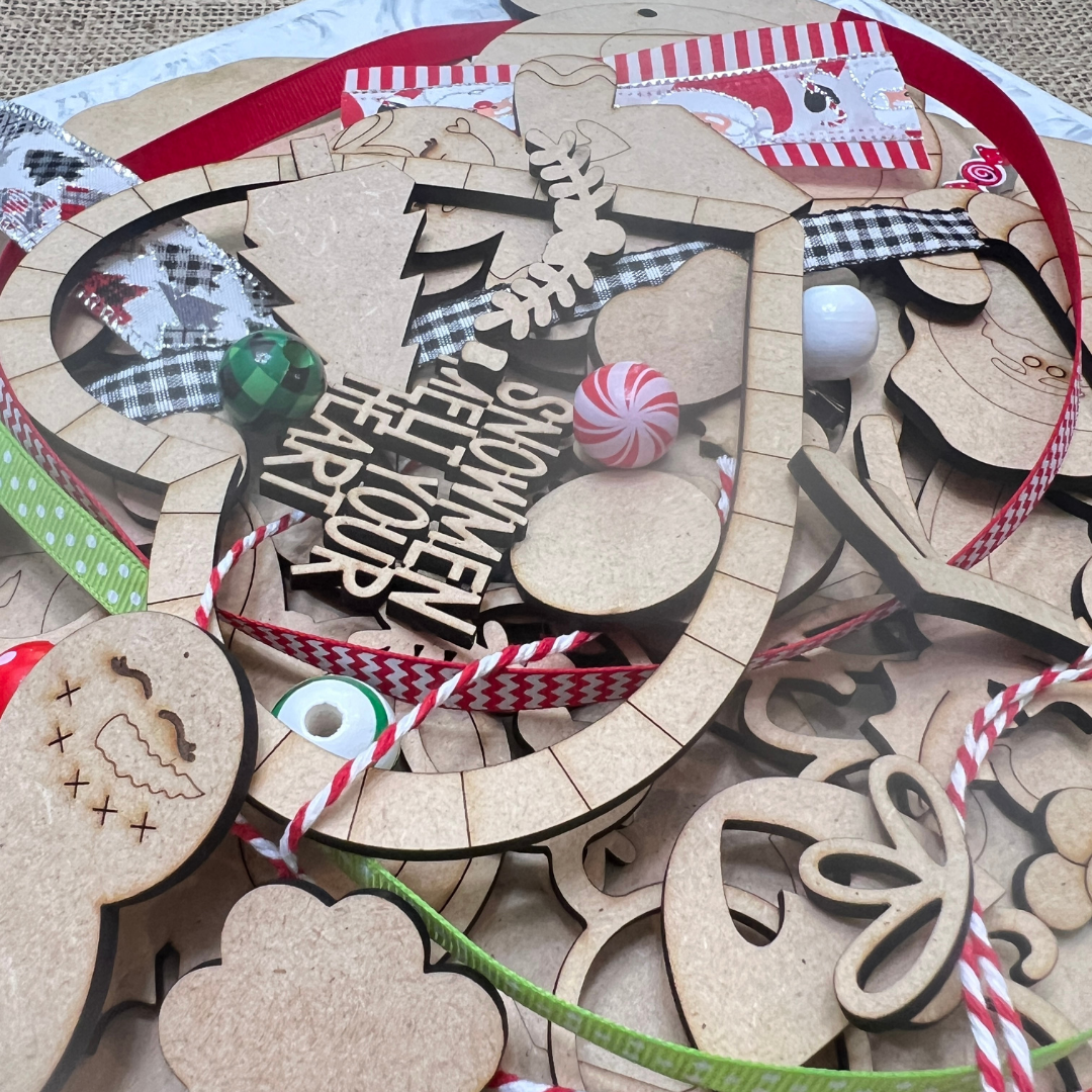 A mix of unfinished wooden Christmas ornaments, ribbons, beads, and candy decorations—ideal for your next Crafted by You! Subscription DIY home decor craft kit from Janet's Craft Corner.