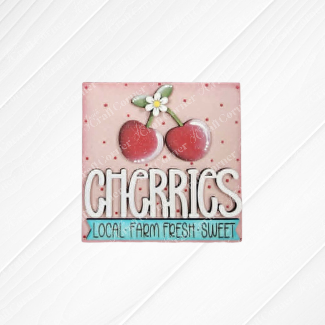 Cherry Squares - DIY seasonal home decor craft kit by Janet's Craft Corner: Features two cherries with a white flower above "CHERRIES" and "LOCAL FARM FRESH SWEET" on a pink polka-dot background—perfect as wood cut-outs or Swappable Squares.
