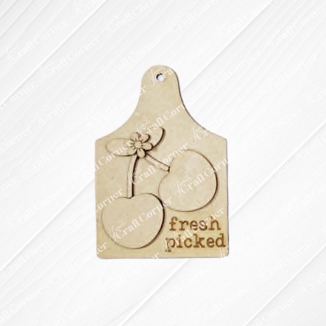 The Cherry Decor Set by Janet's Craft Corner includes a wooden cutting board tag engraved with two cherries, leaves, and “fresh picked”—an ideal unfinished wood craft for farmhouse-inspired DIY home decor accents.