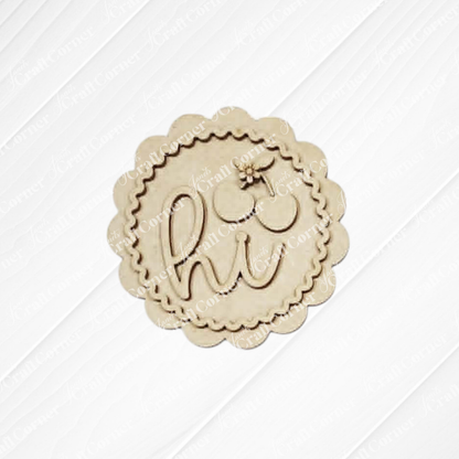 The Cherry Decor Set by Janet's Craft Corner features a round, scalloped unfinished wood cutout engraved with "hi" and a flower above the “i”—ideal for DIY home decor kits or farmhouse accents.