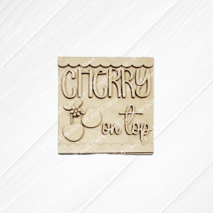 The Cherry Decor Set by Janet’s Craft Corner features a beige square plaque with "Cherry on top" in playful cursive and a cherry illustration—ideal as a DIY home décor kit or a cute farmhouse accent for any space.