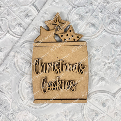 The Vintage Santa Cookies Decor Set by Janet's Craft Corner is a DIY craft kit featuring 6 charming cookie shapes—ideal festive accents for your tiered tray or holiday home decor, shown here on a textured white surface.