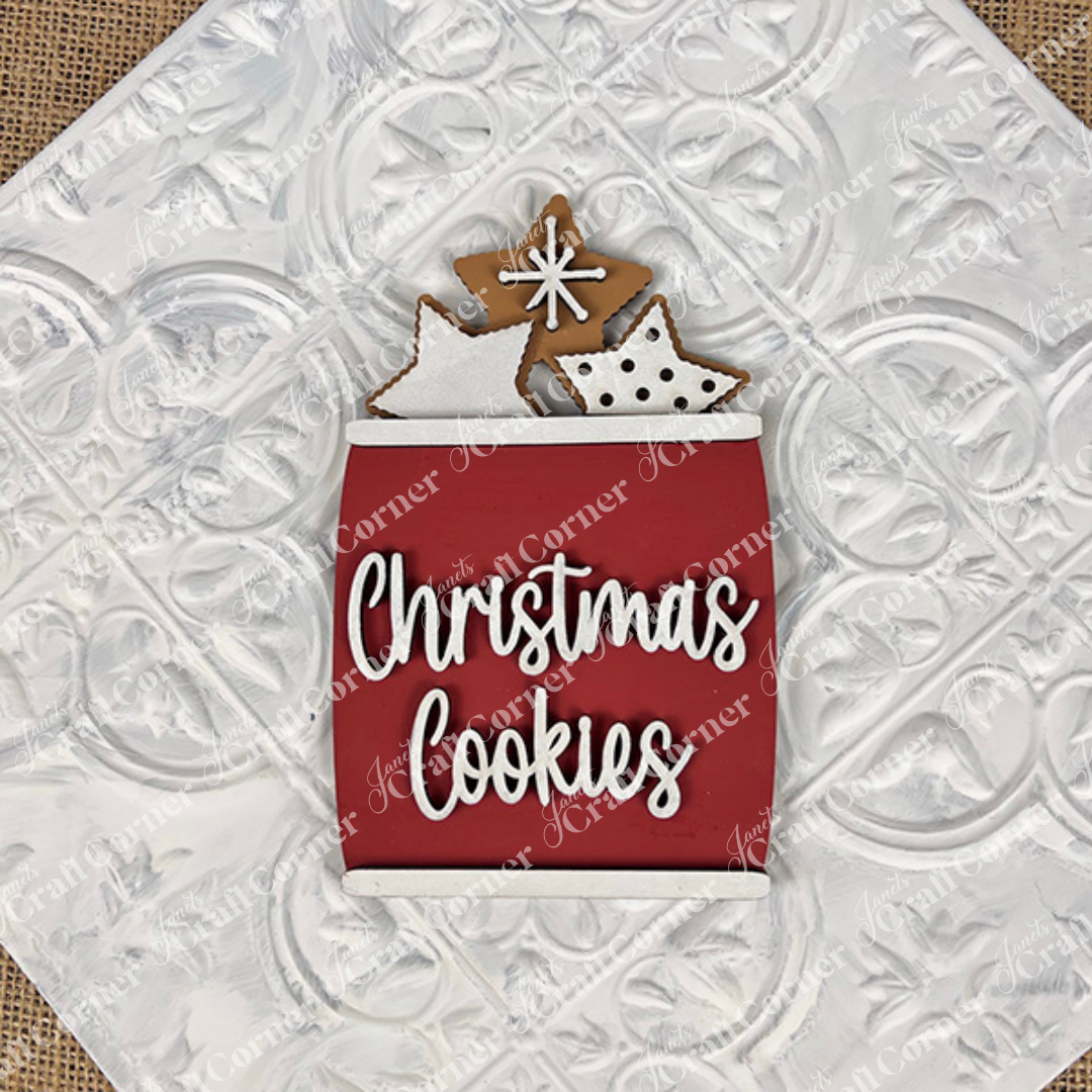 The Vintage Santa Cookies Decor Set DIY craft kit by Janet's Craft Corner features a charming red jar labeled "Christmas Cookies" with star-shaped cookies—perfect for holiday home decor or styling your festive tiered tray.