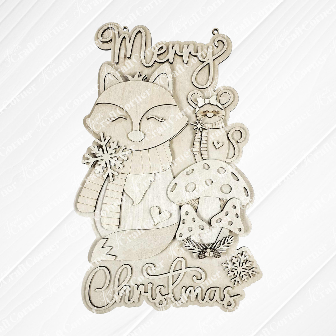 Janet's Craft Corner Christmas Fox Door/Wall Hanger DIY kit features a fox in a scarf, mouse with candy cane, mushrooms, snowflakes, and "Merry Christmas"—perfect for festive decorating or as a fun craft project. Set of 1.