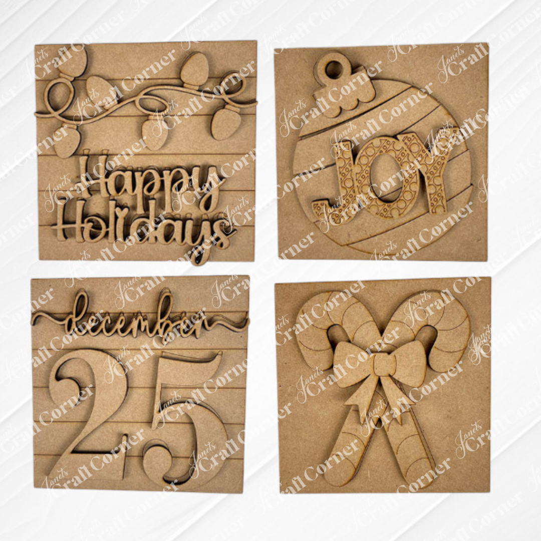 Janet’s Craft Corner Christmas Icon Swappable Squares DIY kit includes four wooden ornaments: “Happy Holidays” with lights, a “JOY” bauble, “December 25,” and crossed candy canes—perfect for your seasonal home decor or craft projects.