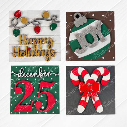 Janet's Craft Corner Christmas Icon Swappable Squares DIY kit includes four festive designs: string lights with "Happy Holidays," a green ornament with "JOY," snowy "December 25" script, and crossed candy canes—perfect for seasonal home decor.