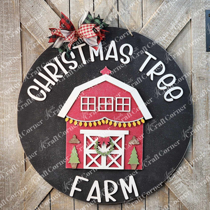 The Christmas Tree Farm Door Hanger DIY Decor Kit by Janet's Craft Corner includes a round sign with a charming wooden texture background, featuring a festive red barn decorated with Christmas trees and a wreath, surrounded by the words "Christmas Tree Farm." It is topped with a red and white plaid bow, making it perfect for home décor projects.
