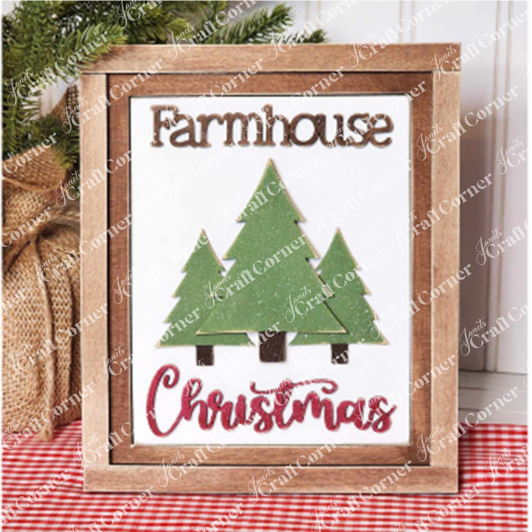 The Christmas Trees Switchable Farmhouse Sign from Janet's Craft Corner is a DIY home decor craft kit that features three green trees set within a wooden frame. The word "Farmhouse" elegantly tops the sign, with "Christmas" artistically scripted in red cursive beneath. Completing this charming piece, a burlap-wrapped plant serves as the backdrop, enhancing its festive appeal.