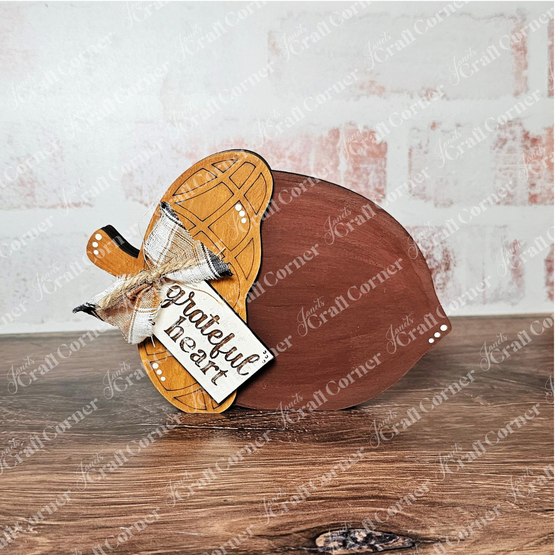 Janet's Craft Corner Fall Chunky Mini Shelf Sitters—DIY seasonal home decor craft kit (choice of 3)—features a wooden acorn with "grateful heart," plaid bow, and wood base, perfect for autumn shelf displays or crafts.