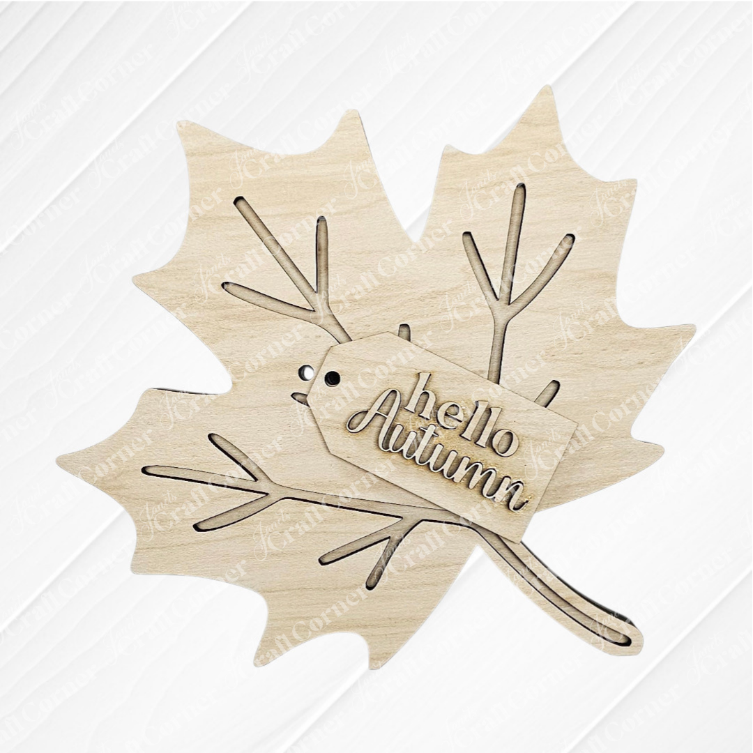 Janet's Craft Corner Fall Chunky Mini Shelf Sitters—DIY seasonal home decor craft kit (Choice of 3)—maple leaf cutout with "hello Autumn" tag, perfect for fall shelves, shown on a white textured background.