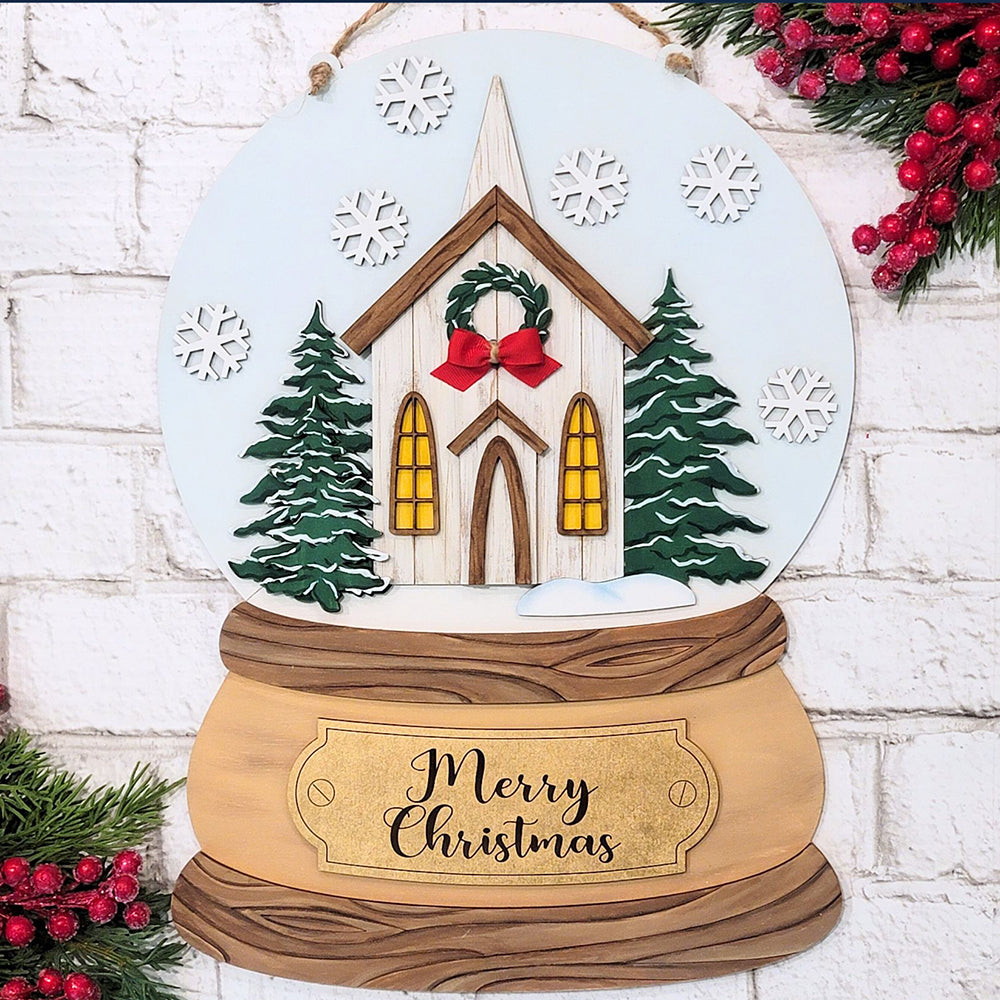 This delightful Rustic Church Snow Globe Sign DIY Decor Kit from Janet's Craft Corner is a festive wooden decoration that features glowing windows, green trees, and snowflakes. With a "Merry Christmas" sign and red berries along with pine branches framing the scene, it's an ideal addition to your home décor.