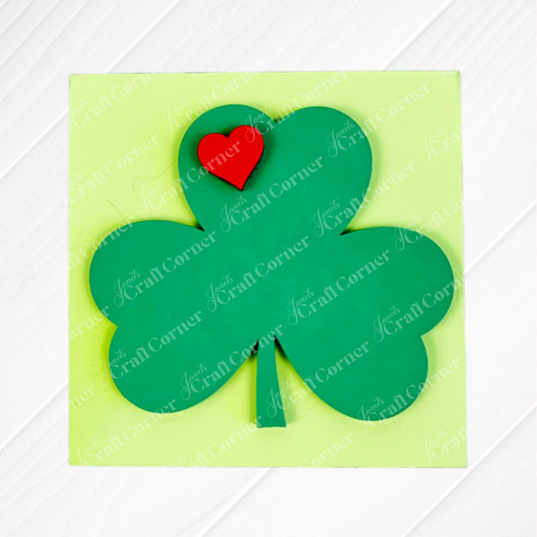 The St Patricks Squares from Janet's Craft Corner feature a green three-leaf clover with a red heart above the left leaf, centered on a pale yellow square—ideal for tiered tray decor or as delightful wooden cut-outs.