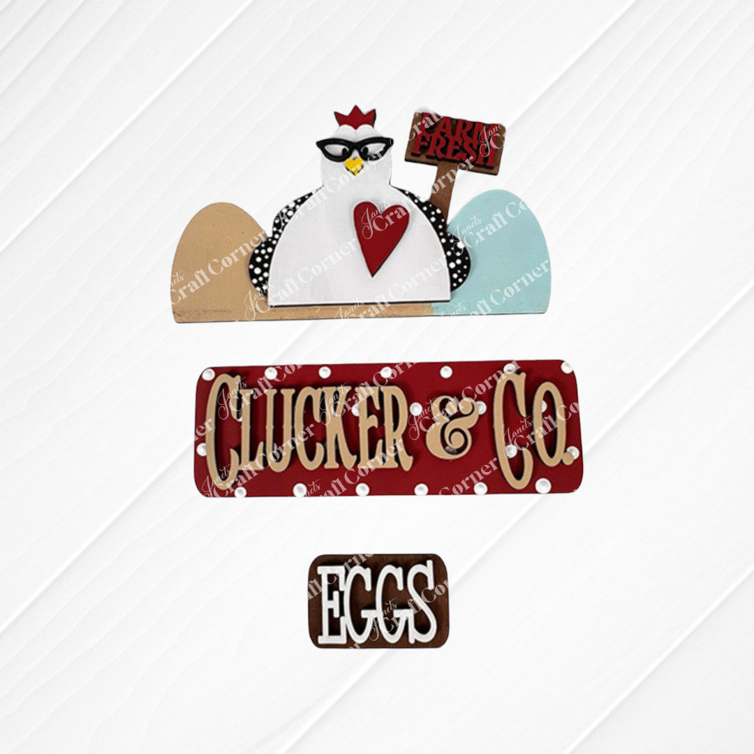 A textured decorative sign set includes a cartoon chicken motif wearing glasses and a "Farm Fresh" sign, accompanied by the illuminated red Clucker & Co. sign by Janet's Craft Corner, which adds rustic charm alongside a brown "Eggs" sign, ideal for interchangeable craft inserts.